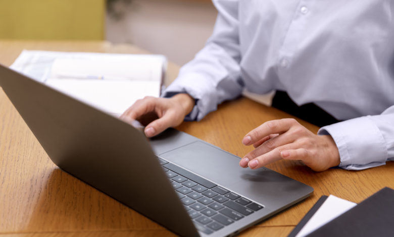 Man writing cover letter on laptop